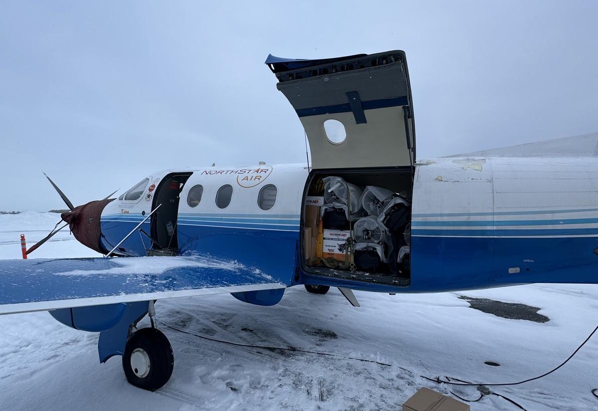 Freight going aboard a turboprop on a community airstrip