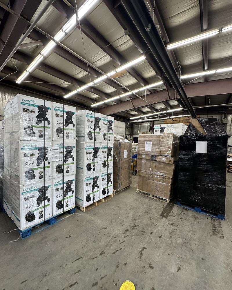Pallets of boxed strollers staged in the warehouse