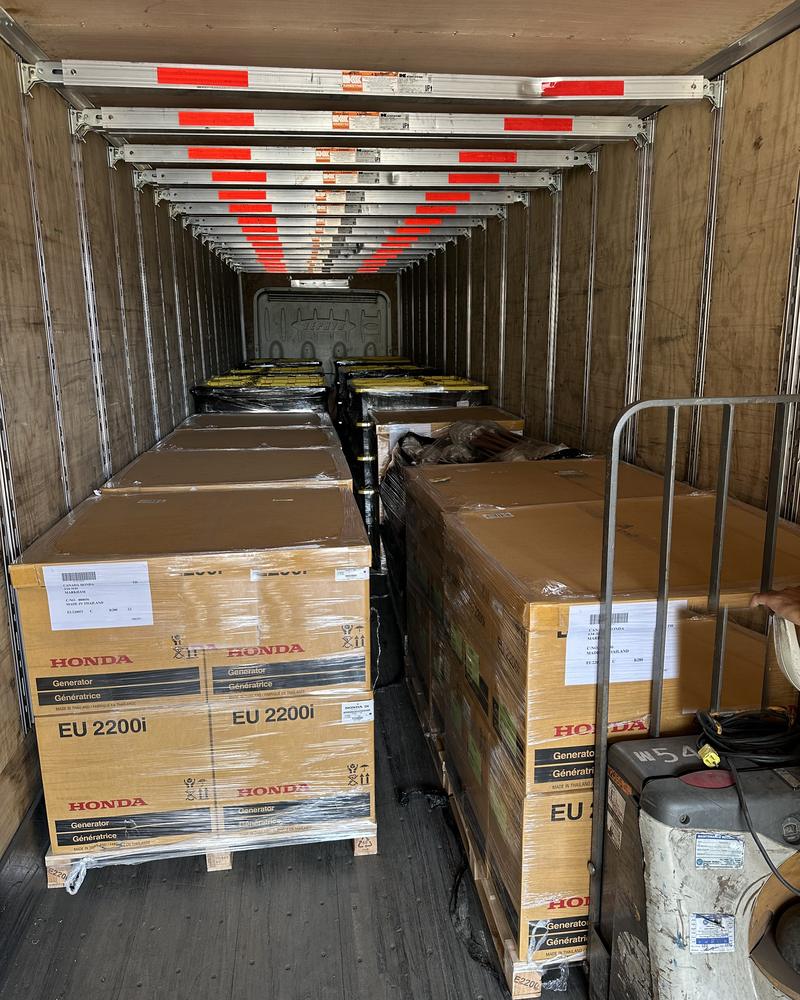 Generators loaded and tagged down the length of a trailer